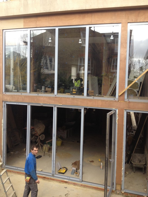 Aluminium bi-fold doors with two-storey glazing in Welwyn Garden City