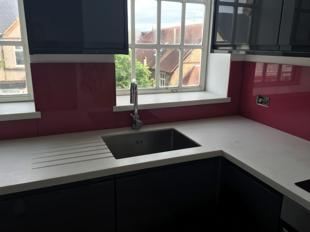 Deep plum coloured glass splashback in modern Welwyn Garden City kitchen